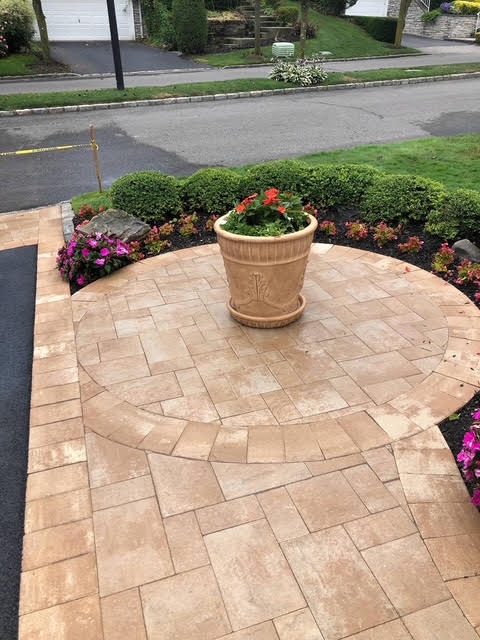 Curved paver front walkway and landing with planter