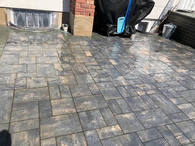 Large-format gray paver patio with grill station