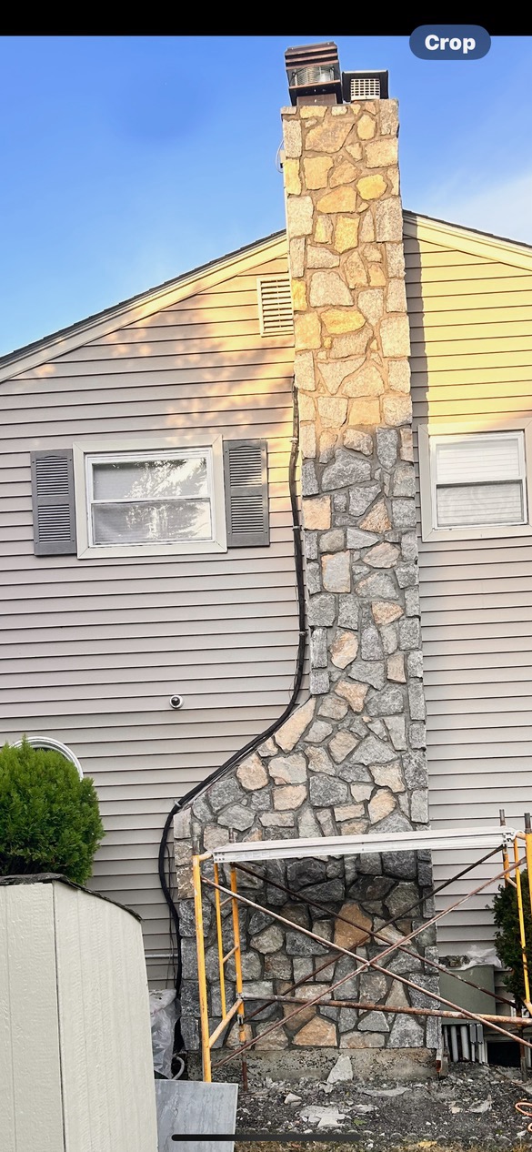 Chimney clad in natural cultured stone