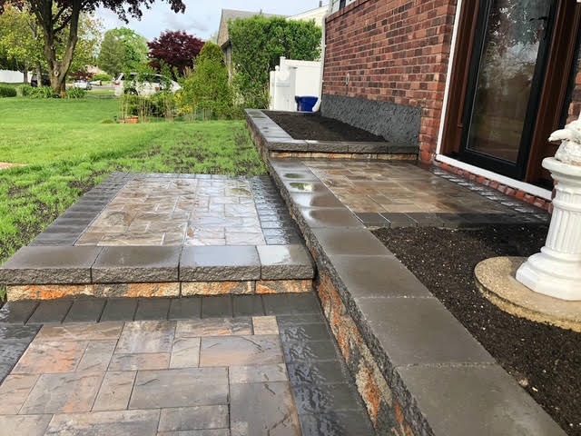 Stone walkway leading along the side of a home