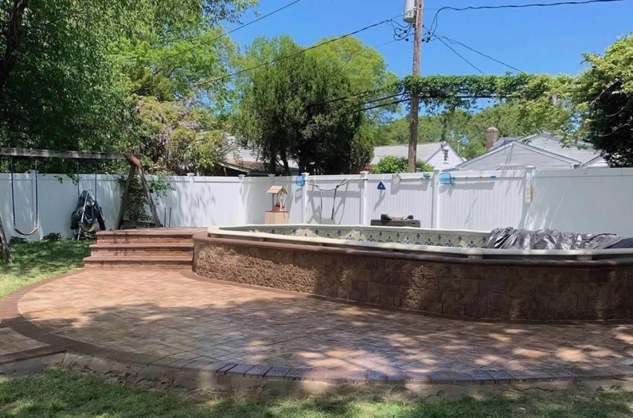 Raised patio with stone retaining wall under construction